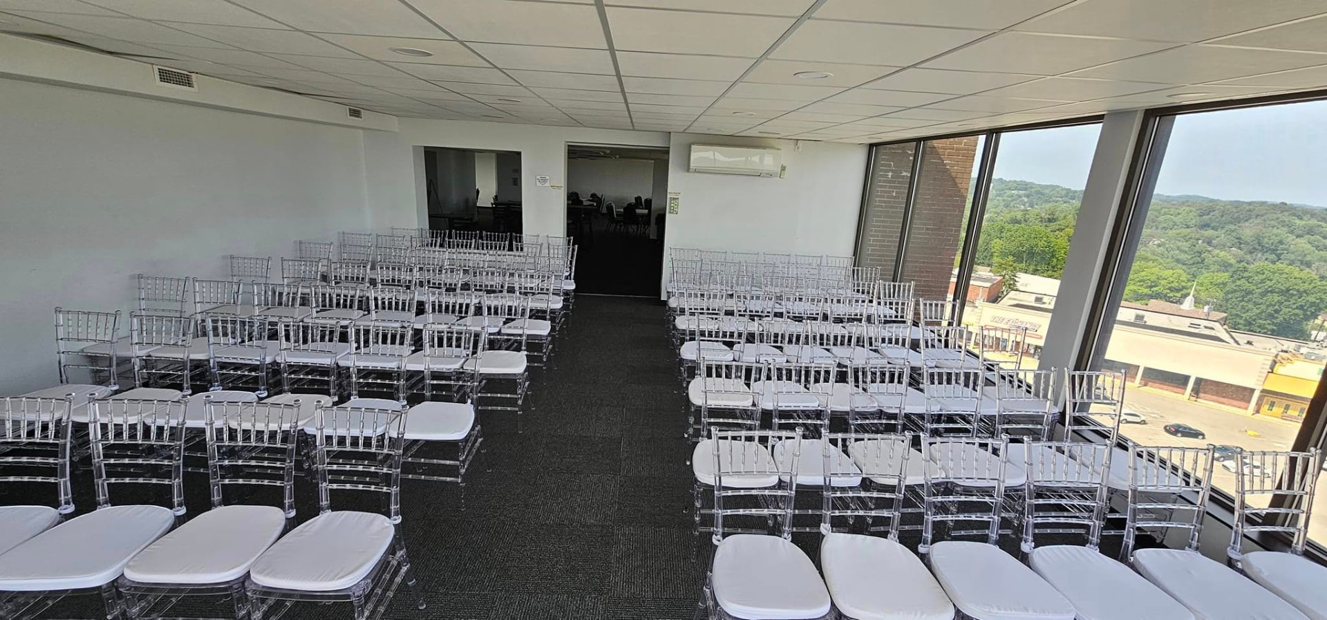 Ceremony seating arranged beside the windows